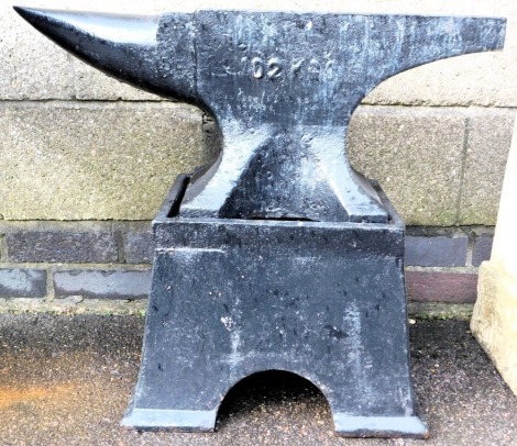 A black painted anvil, on stand, with raised and stamped serial numbers, 70cm wide.