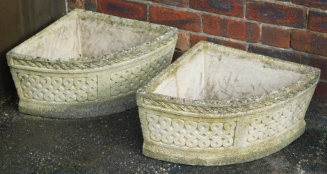 A pair of Cotswold Studios concrete corner planters, with Celtic knot decoration, impressed marks, 63cm wide.