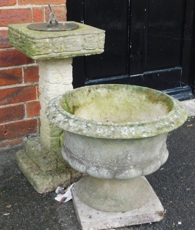 A concrete garden sundial, with a square top, raised on a column of wood form, on a stepped square base, 63cm high, together with a concrete garden urn, of semi fluted form, raised on a square base, 49cm wide. (2)