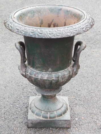 A Victorian cast iron garden urn, painted green, of campana form, 42cm high.