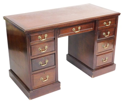 An mid 20thC mahogany twin pedestal desk, with a leatherette inset top, above a central drawer and two pedestals, with four drawers to the left, two drawers and a double filing drawer to the right, each raised on a plinth base, 75cm high, 122cm deep, 58cm