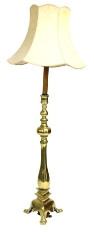 An early 20thC Anglo-Indian brass standard lamp, of turned form, raised on a trefoil base, lion's head capped, 152cm high.