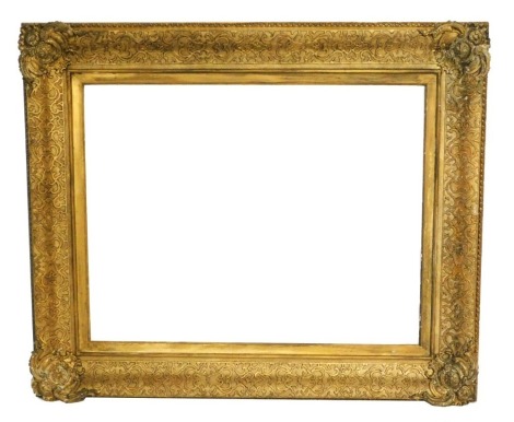 A 19thC giltwood picture frame, with scroll carving, 122cm x 102cm wide, aperture 90cm x 70cm.