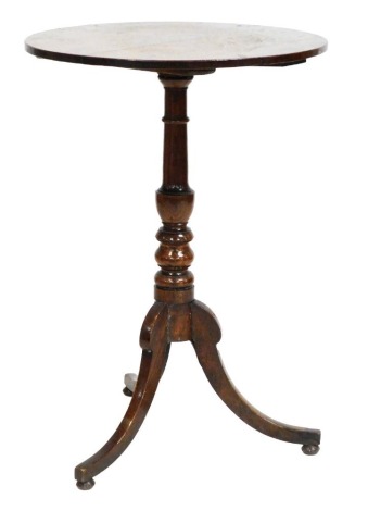 A George III oak occasional table, the circular top raised on a turned column over three out swept legs, on ball feet, 73.5cm high, 51cm wide.