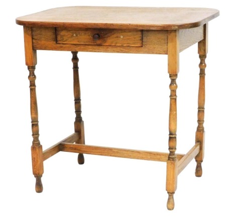 An early 20thC oak side table, with a single frieze drawer, raised on turned legs united by a H framed stretcher, 73cm high, 76cm wide, 51cm deep.