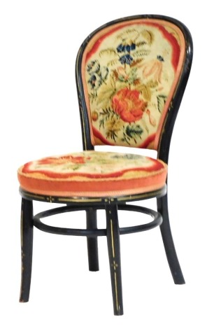 A Victorian ebonised and woolwork balloon back chair, with floral upholstery, raised on out swept legs.