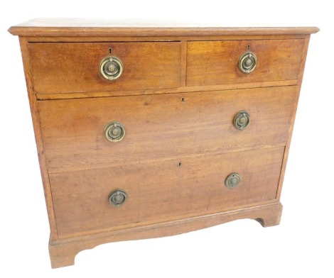 An Edwardian oak chest, of two short over two long drawers, raised on bracket feet, 80cm high, 92cm wide, 51cm deep.