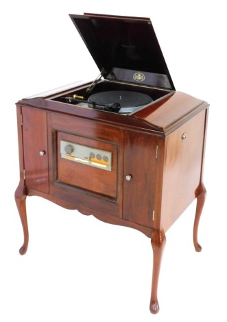 An Electron mahogany cased radiogram, the hinged lid opening to reveal a Thornes TD160 Super turntable, with radio and tape player, the cabinet with two side drawers, raised on cabriole legs, 91cm high, 75cm wide, 49.5cm deep.