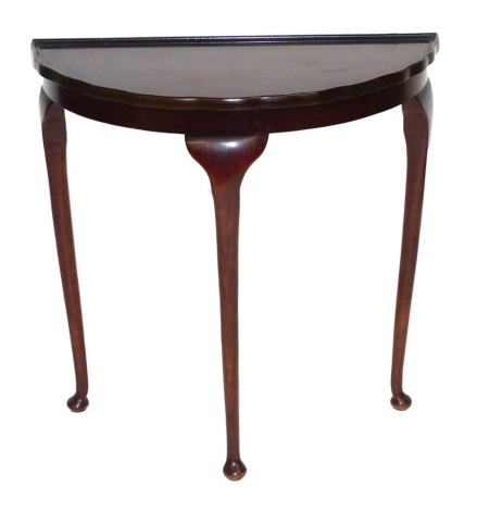 A mahogany demi lune hall table, raised on cabriole legs, 73.5cm high, 72cm wide, 36.5cm deep.