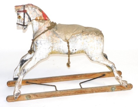 A vintage red and white painted wooden rocking horse, 122cm wide.