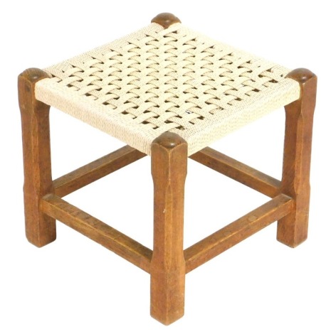 A mid Century oak and rattan stool, 30cm wide.