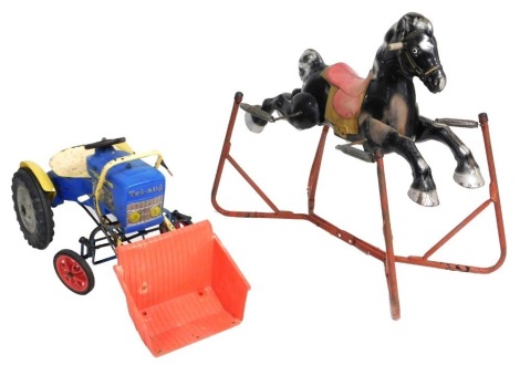 A Triang tin plate rocking horse, 97cm wide, together with a Triang plastic and cast iron ride on tractor, 102cm wide. (2).