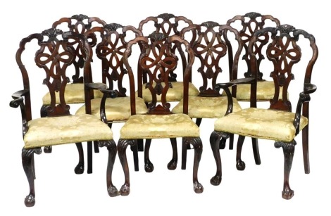 A set of eight Chippendale style mahogany dining chairs, with foliate carved crest rail, Celtic knot carved splat, and overstuffed seats, in gold floral upholstery, raised on leaf carved cabriole legs, on ball and claw feet, including a pair of carvers.