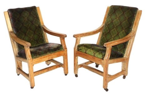 A pair of turn of the century pitch pine armchairs, upholstered with overstuffed back and seat, upholstered in green and geometric fabric, 56cm wide.