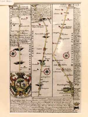 After Owen and Bowen. Double sided map of the road from Royston to Stamford via Huntingdon and Stilton, circa 1720, hand coloured, 18cm x 12cm, together with a 19thC walnut and line inlaid swing frame miniature mirror, 27cm high, and an oak frame on strut - 2