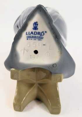 A Lladro porcelain figure, modelled as a seated nun completing needlepoint, printed marks, 21cm high. - 3