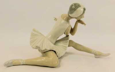 A Lladro porcelain figure, modelled as a seated ballerina, 12cm high, boxed. - 2