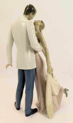 A Lladro porcelain figure group, modelled as a lady and gentleman in formal dress embracing, printed marks, 32cm high. - 2