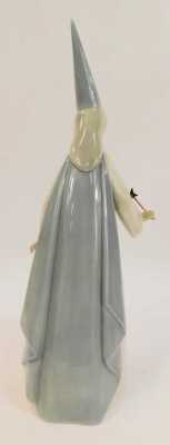 A Lladro porcelain figure, modelled as Fairy Godmother with wand, printed marks, 27cm high. - 2