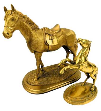 A 20thC brass figure modelled as a rearing horse, on an oval base, 25cm high, together with a Leonardo Collection gilt model of a horse wearing a saddle, on a stepped base, 34cm high.