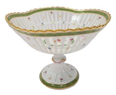 A Haviland Limoges porcelain comport, the pierced basket top with floral and gilt decoration, on a circular foot, printed marks, 17cm high.