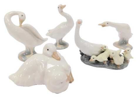 A group of Lladro and Nao porcelain, comprising three standing Lladro geese, a Nao duckling group, and a Lladro group comprising geese and goslings. (5)