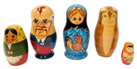 Six Russian wooden Matrieshka nesting dolls, comprising USSR Presidents, the largest 15cm high, cats, and three in regional dress.