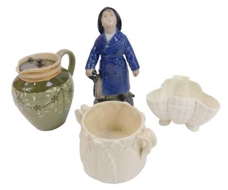 A Royal Copenhagen porcelain figure, modelled as a boy wearing a raincoat and holding an umbrella, number 3556, printed marks, 19cm high, together with a James Macintyre and Co faience jug, with pewter lid, printed marks, 12cm high, and two pieces of Roya