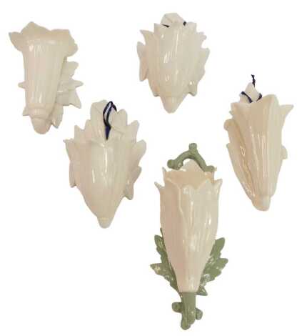 Five late 19thC Grainger & Co Worcester porcelain wall hanging posy holders, each of flower head design, each cream glaze, one cream and green glaze, the largest 14.5cm high.