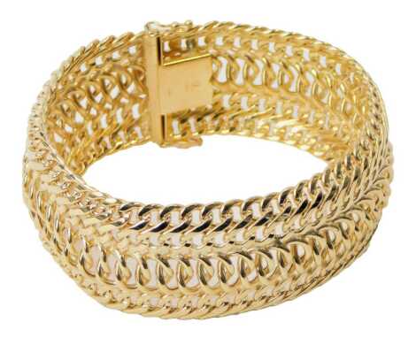 A 9ct gold three strand bracelet, of curb and oval link form, on a snap clasp, 20.5cm long, 32.6g.