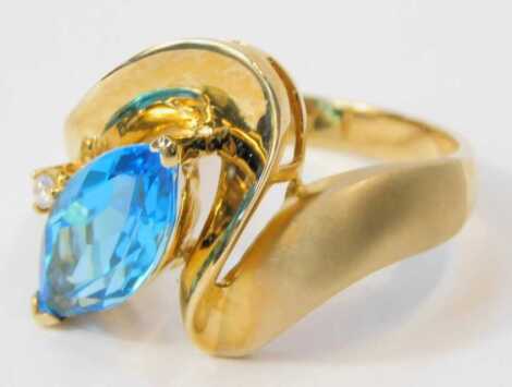 A 9ct two colour gold topaz and diamond ring, in an abstract geometric setting, with a marquise cut topaz, size R, 5.7g.