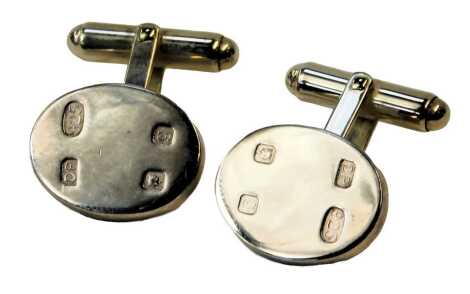 A pair of silver cufflinks, each with oval front and hallmarked design, maker DP, London 2006, 12.4g all in.