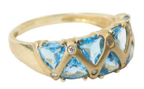 A 9ct gold and topaz ring, set with seven triangular cut stones, interspersed with tiny diamonds, size S, 3.4g.