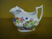 A Victorian London shape creamer with polychrome chinoiserie decoration