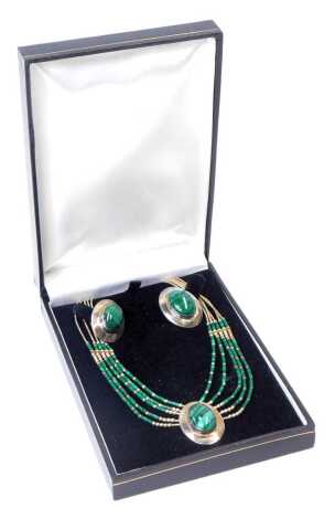 A silver and malachite pendant on a five strand chain, together with a pair of matching earrings, cased.