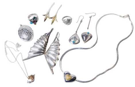 A group of silver jewellery, including earrings, pendants on chains, and rings. (a quantity)