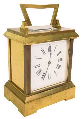 A 20thC brass cased carriage clock, the white square enamel dial bearing Roman numerals, key wind, 14.5cm high, with key.