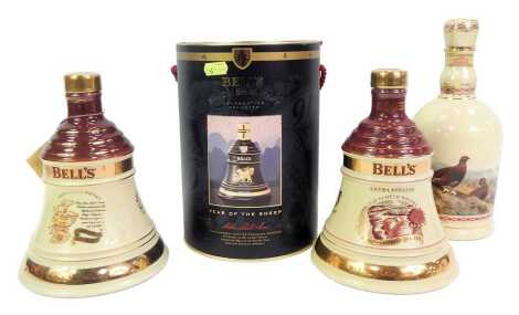 Three Bell's Scotch whisky decanters, comprising Christmas 1996, 1997, Year of the Sheep, boxed, and a Famous Grouse Highland whisky decanter, each with contents.