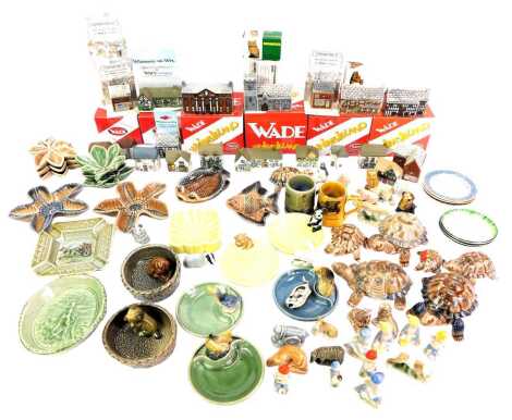 A group of Wade collectables, to include Coronation Street buildings, Whimsies, pin trays, tortoise trinket box and covers, ashtrays, etc. (2 trays)