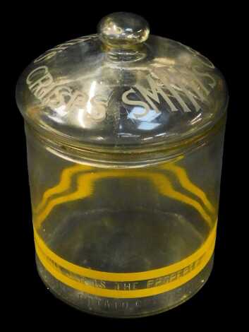 A Smiths clear glass crisp jar and cover, with yellow double banding to base, 27cm high.