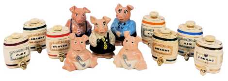 NatWest Wade pottery pig money banks, comprising Mother, Father, Daughter and two Babies, together with seven Wade pottery alcohol barrels for Scotch, Gin, Rum, Sherry (2), Port and Cognac.