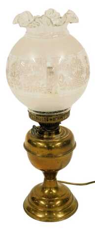 An early 20thC oil lamp, the frosted and clear glass shade decorated with bows, swags, etc., on a brass base, converted to electricity, with chimney, 53cm high.WARNING!  This lot contains untested or unsafe electrical items.  It is supplied for scrap or r