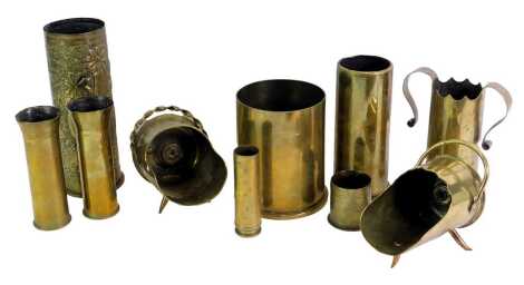 Trench Art. A group of brass shell cases converted into vases, one with hammered floral design stamped Dusseldorf 1909, a pair of Art Nouveau style shell cased with arched handles bearing crest and dated 1917, etc. (2 trays)