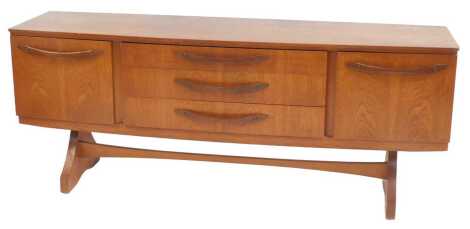 A Beautility teak sideboard, the rectangular top above three drawers flanked by two cupboards, on shaped legs, united by stretcher, 74cm high, 182cm wide, 48cm deep.