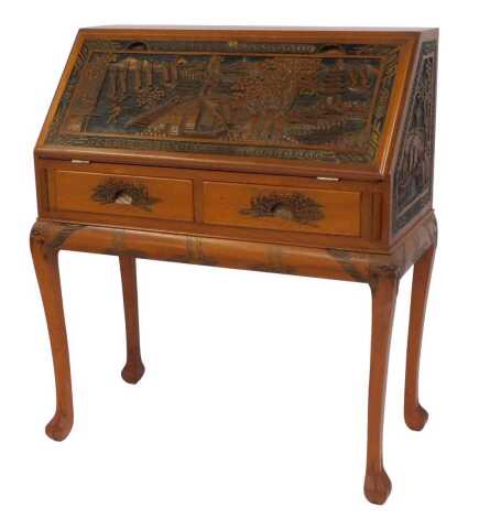 An Oriental carved hardwood bureau, the fall carved with figures, bridge, sailing boats and pagoda, with carved sides, above two carved drawers, on cabriole legs with paw feet, 103cm high, 90cm wide, 45cm deep.