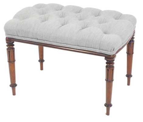 A 19thC mahogany footstool, with overstuffed button upholstered top, raised on cylindrical legs with lappet decoration, 44cm high, 62cm wide, 41cm deep.