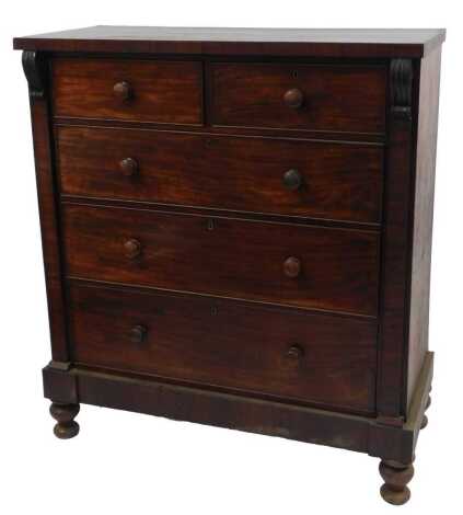 A Victorian mahogany chest, of two short over three long drawers, flanked by scroll carving, on an inverted breakfront base with later added turned feet, 144cm high, 120cm wide, 53cm deep.