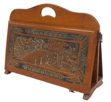 An Oriental hardwood carved magazine rack, carved to the front and back with figures on a bridge amongst pagoda, tree, etc., on shaped end supports, 34cm high, 45cm wide, 16cm deep.