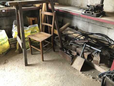 A corner steel work bench and steel sundries underneath.