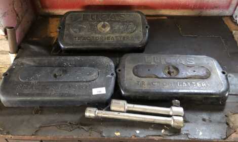 Three Ferguson TEF20 battery covers and a Ferguson wheel brace.